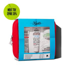 Kiehl's travel-sized skincare gift set in a red pouch, featuring multiple products visible through a blue-themed window.