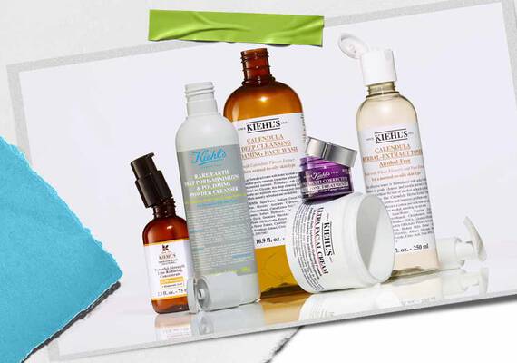 Eine Kollektion von Kiehl's Hautpflegeprodukten, darunter Lotionen und Seren, kunstvoll arrangiert mit leuchtenden Verpackungen und sichtbaren Etiketten.