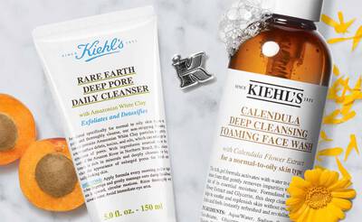 Kiehl's Gesichtsreiniger: Rare Earth Deep Pore Cleanser und Calendula Foam Cleanser neben Bluten und einer Aprikose.