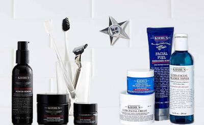 Hautpflegeprodukte von Kiehl's: Seren, Creme, Toner und Zubehor auf einem weißen Fliesen-Hintergrund.