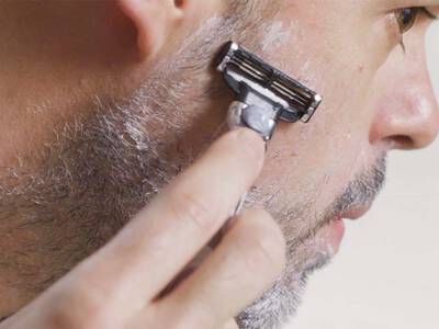 Mann mit Bart der sich rasiert