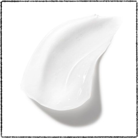 A smooth, glossy swatch of white cream on a white background.
