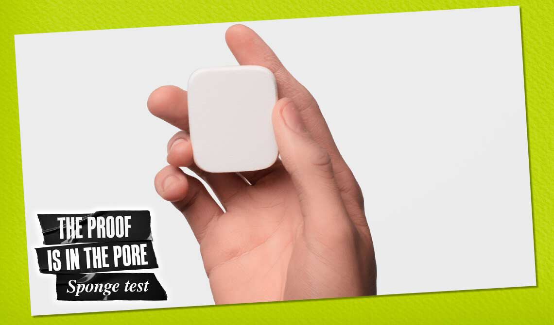 Hand halt einen weißen Schwamm, mit dem Text „THE PROOF IS IN THE PORE – Sponge test“ auf grunem Hintergrund.